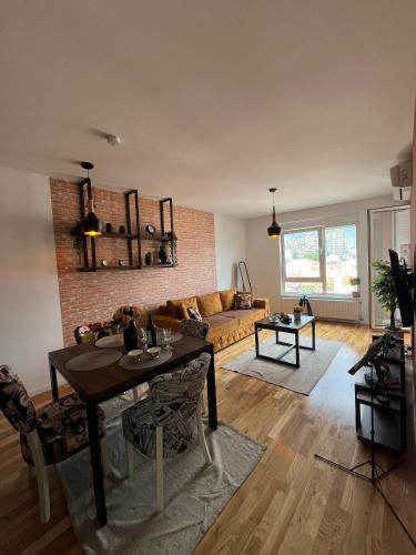 a living room with a couch and a table at Lux apartment 13 center, free parking in Niš