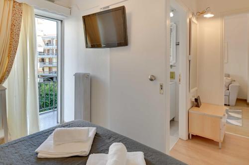 a bedroom with a bed with a television on the wall at Academia stay ήσυχα & στο Κέντρο in Ioannina