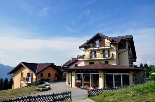 a large house on top of a hill at Hotel Residence Bellavista - Camping Polsa in Brentonico