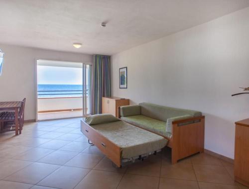 a room with a couch and a table and a window at Sognu di Rena privilege Top appartament view sea in San-Nicolao