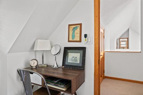 a room with a desk with a mirror and a clock at Casa Azur in Union Pier