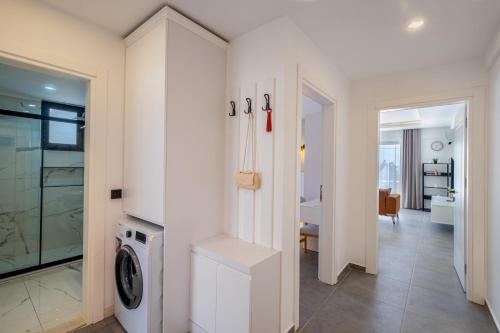 a laundry room with a washer and dryer in a house at Meri Suite Apart Kaş in Kas