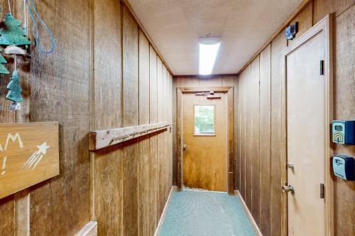 a hallway with wood paneled walls and a door at Bee Branch 35 in Sugar Mountain