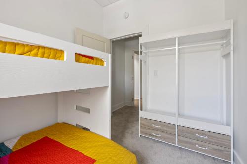a bedroom with a bunk bed and a mirror at City View Loft in Saint Joseph
