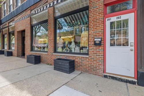 a store with a white door and a brick building at City View Loft in Saint Joseph