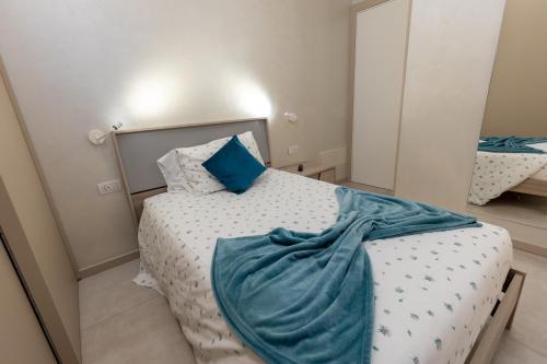 a bedroom with a bed with a blue blanket on it at Villa Vitali - Bellagio in Bellagio