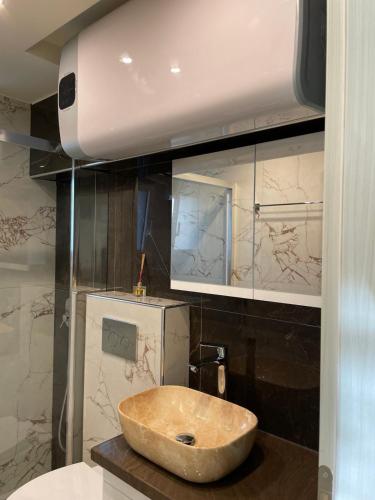a bathroom with a sink and a mirror at BLUE STAR Apartments #8 in Paralia Katerinis