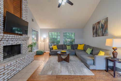 a living room with a couch and a fireplace at Fun 'n Sun Heated POOL & GameRoom by Fiesta Texas in San Antonio
