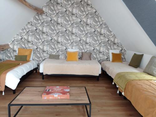 a living room with three couches and a table at Écuries Val de Mai 35 pers 5 Gîtes 15 min Amiens in Talmas