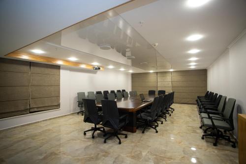 a conference room with a long table and chairs at Hotel Black Sea in Batumi