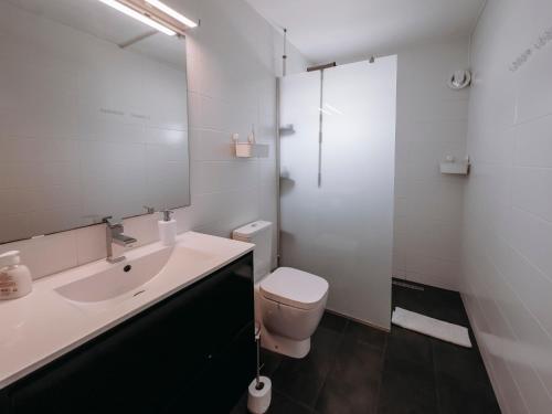 a bathroom with a sink and a toilet and a mirror at Viking Family Superior Lux in Ayia Napa