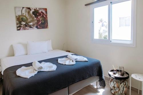 a bedroom with a bed with towels on it at Viking Family Superior Lux in Ayia Napa