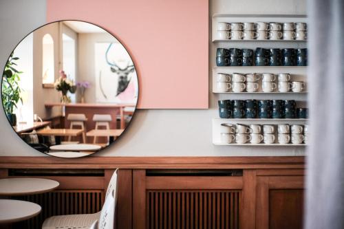 a mirror on the wall of a restaurant at The Townhouse Ruhpolding - Individual Design & Casual Concept in Ruhpolding