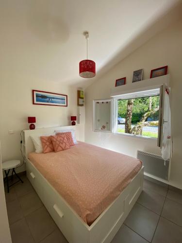 une chambre avec un lit et une fenêtre dans l'établissement maison de lachanau, à Hourtin