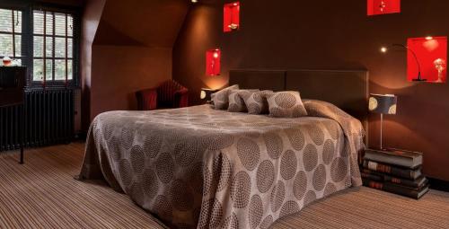 a bedroom with a bed with a white comforter at Château de Saint Paterne in Saint-Paterne
