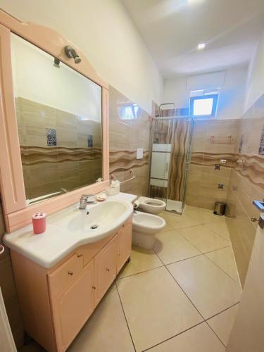 a bathroom with a sink and a toilet at Ottaviano B&B in Ottaviano
