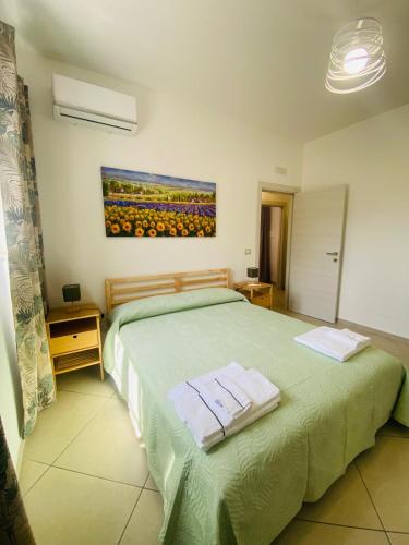 a bedroom with a bed with two towels on it at Ottaviano B&B in Ottaviano