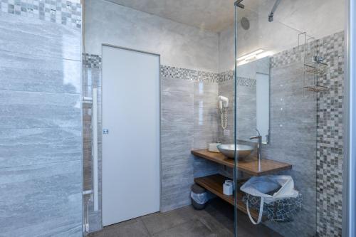 a bathroom with a glass shower and a sink at Villa Vitali - Bellagio in Bellagio