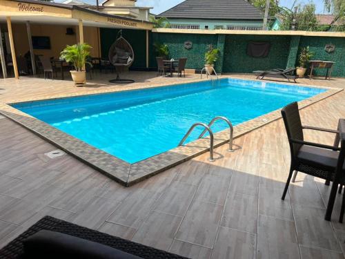 a large swimming pool with blue water at Presken Shonibare Estate in Lagos