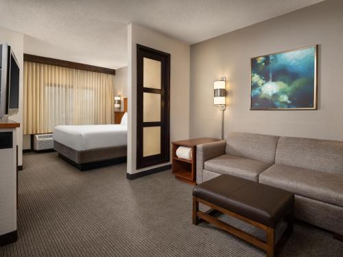 a hotel room with a couch and a bed at Hyatt Place Columbus/Dublin in Dublin