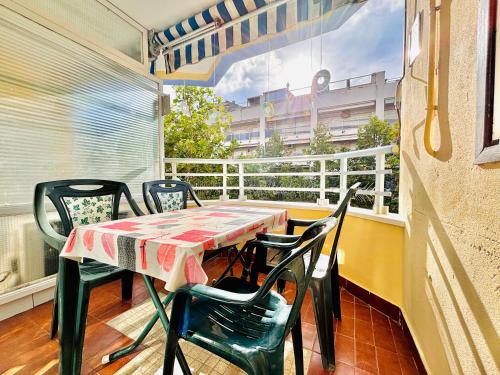 a balcony with a table and chairs on a balcony at COSTA DAURADA APARTAMENTS - Alboran II in Salou