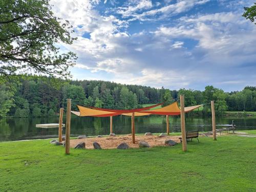 a tent in a field next to a lake at Appartement am See in Litschau
