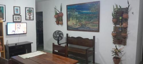 a dining room with a table and a chair and a table sidx sidx at Apartamento Praia do Janga Paulista Pe in Paulista