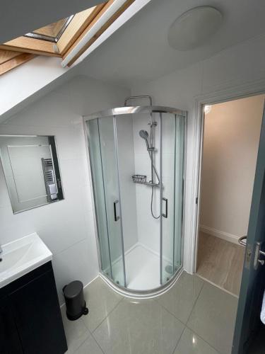 a bathroom with a shower with a glass shower stall at 1 Bedroom Flat in Bedford in Bedford