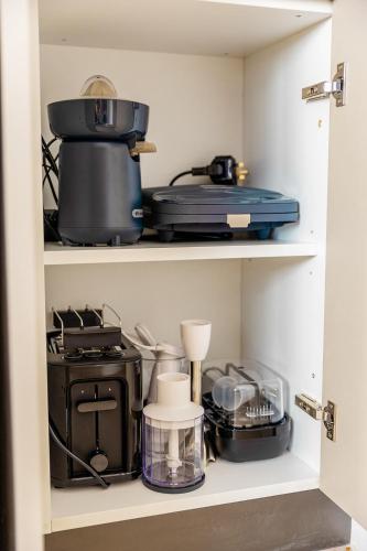 a cupboard filled with lots of kitchen items at Characterful ground floor townhouse in Tal-Għoqod