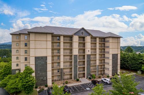 an apartment building with a parking lot at Mountain View Condo 1205 by Eden Crest in Pigeon Forge