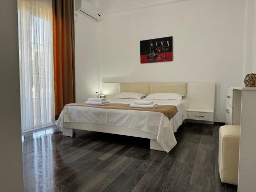 a bedroom with a large bed in a room at Villa August Ksamil in Ksamil