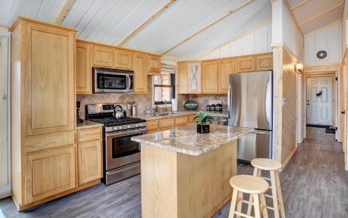 a kitchen with wooden cabinets and a stainless steel refrigerator at Warrick Cabin in Creede