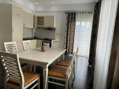 a kitchen and dining room with a table and chairs at Villa August Ksamil in Ksamil
