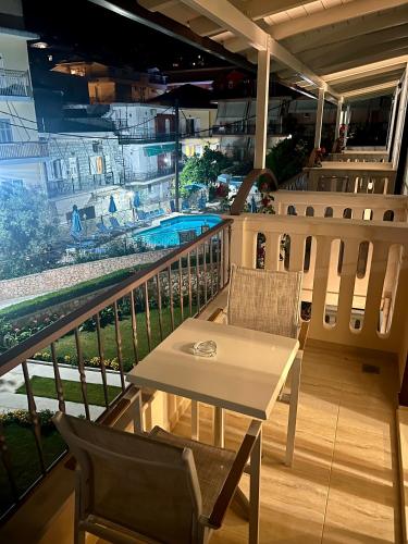 a balcony with a table and chairs on a cruise ship at Valentinos House in Parga