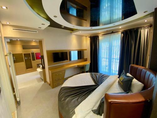 ein Schlafzimmer mit einem Bett und einem TV in einem Zimmer in der Unterkunft Grand Hotel Van in Van