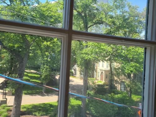 a window with a view of a yard at Iconic Luxurious Downtown Building History Galore in Halifax