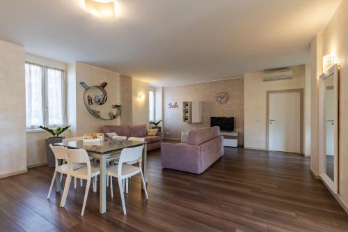 a living room with a table and a couch at Villa Vitali - Bellagio in Bellagio