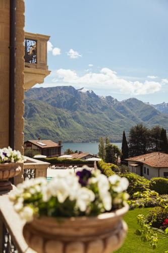 a vase of flowers on a balcony with a view at Villa Vitali - Bellagio in Bellagio