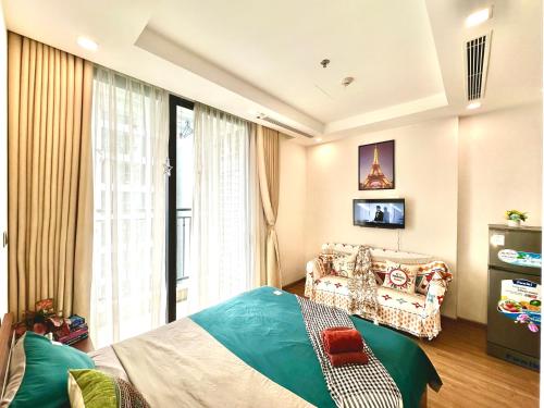 a bedroom with a bed and a couch and a tv at Deluxe Studio Next National Convention Centre And Marriott Hotel in Hanoi