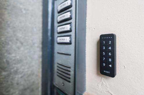 a close up of a remote control on a wall at Ty Ayla Premier Apartments - Roath Park in Cardiff