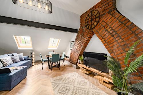 a living room with a large brick wall with a fireplace at Ty Ayla Premier Apartments - Roath Park in Cardiff