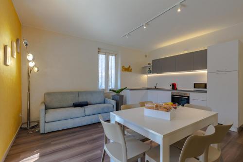 a kitchen and living room with a table and a couch at Villa Vitali - Bellagio in Bellagio