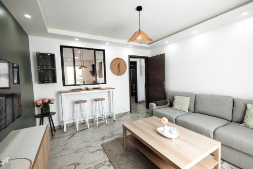 a living room with a couch and a table at Royale Lumineux Jacuzzi Parking privé in Mulhouse