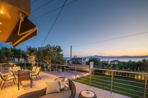 a patio with furniture and a view of the ocean at THEA Seaview Luxury Living in Kalamata