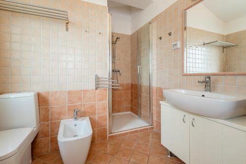 a bathroom with a sink and a toilet and a shower at 2 bedrooms house with city view shared pool and enclosed garden at Ripenda Kras 4 km away from the beach C in Ripenda Kras