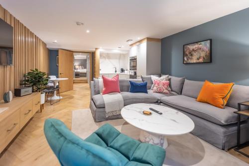 a living room with a couch and a table at No1 Apartments Edinburgh - New Town in Edinburgh
