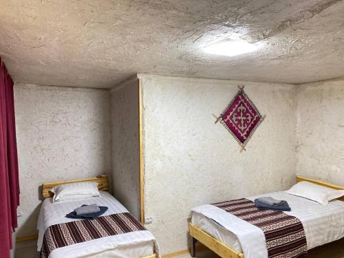 two twin beds in a room with a ceiling at Svetlaya Polyana in Svetlaya Polyana