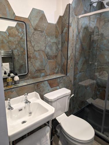 a bathroom with a toilet and a sink at The Chelsea in Llandudno
