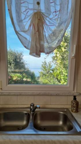 a kitchen sink in front of a window at Patty's Cottage with private PARKING in Lerici