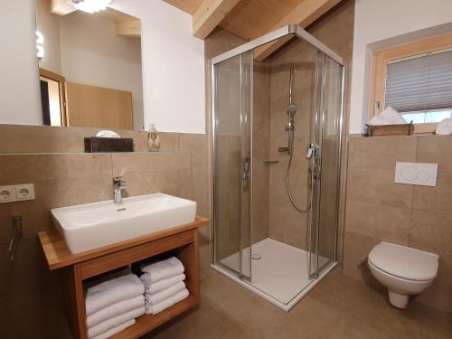une salle de bain avec lavabo et douche dans l'établissement Filzsteinresort Chalets - Chalet 240, à Krimml